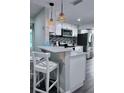 Bright kitchen featuring white cabinets, stainless steel appliances, and a stylish breakfast bar at 637 Ash Ave, Daytona Beach, FL 32117