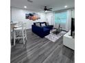 Bright living room with modern decor, a comfortable blue sectional, and sleek flooring at 637 Ash Ave, Daytona Beach, FL 32117