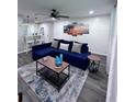 Cozy living room with a comfortable blue sectional couch, stylish decor, and ample natural light at 637 Ash Ave, Daytona Beach, FL 32117