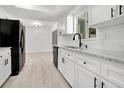 Modern kitchen featuring white cabinets, granite countertops, and stainless steel appliances at 6426 Sw 60 Ave, Ocala, FL 34474