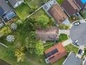 An aerial view showcasing the home's roof, surrounded by lush landscaping and neighboring properties at 655 Eagle Pointe South, Kissimmee, FL 34746