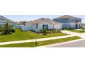 Well-maintained home with a green lawn, white fence, and neat landscaping at 6935 Dilly Lake Ave, Groveland, FL 34736