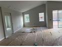 Open-concept living room with vaulted ceilings and lots of natural light at 738 Pointe Emerson Blvd, Apopka, FL 32703