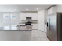 Modern kitchen with a central island, stainless steel appliances, and granite countertops at 849 Teton St, Haines City, FL 33844