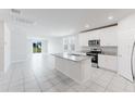 Bright kitchen features white cabinets, granite countertops, and stainless steel appliances at 849 Teton St, Haines City, FL 33844