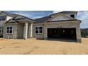 An unfinished exterior of a single-Gathering home shows the block construction and attached two-car garage at 873 Pointe Emerson Blvd, Apopka, FL 32703