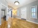 Inviting foyer featuring hardwood floors, neutral paint, and a modern lighting fixture at 1122 Vassar St, Orlando, FL 32804
