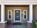 Welcoming front entrance featuring a classic blue door, stone accents, and stylish lighting fixtures at 1122 Vassar St, Orlando, FL 32804