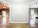Open hallway with two bedroom views, hardwood floors, and neutral wall colors at 1122 Vassar St, Orlando, FL 32804