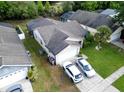 Aerial view of a single story home with screened in enclosure and well manicured lawn at 1567 Oak Hill Trl, Kissimmee, FL 34747