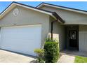Charming single-story home featuring an attached garage, well-maintained landscaping, and a welcoming front entrance at 1567 Oak Hill Trl, Kissimmee, FL 34747