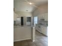 Kitchen with a center island and white cabinets at 1567 Oak Hill Trl, Kissimmee, FL 34747