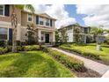Inviting two-story home with manicured lawn, brick walkway, and charming architectural details at 16261 Admirals Cove Ln, Winter Garden, FL 34787
