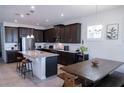 Spacious kitchen featuring dark wood cabinets, granite countertops and stainless steel appliances at 16274 Taliesin St, Winter Garden, FL 34787
