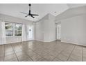 Bright living room showcasing tile flooring, large windows, and a contemporary ceiling fan at 1701 Smoketree Cir, Apopka, FL 32712
