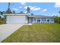 Charming single-story home with an attached two-car garage and a pristine, well-maintained lawn at 17787 Sw 22Nd Ave, Ocala, FL 34473
