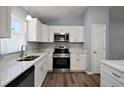 Kitchen with stainless steel appliances, white cabinets, and stone countertops at 17787 Sw 22Nd Ave, Ocala, FL 34473