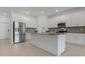Modern kitchen features stainless steel appliances, gray backsplash, and a center island at 1908 Blissful Dr, Kissimmee, FL 34744