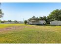 Expansive lot featuring a cozy home with a covered porch and a storage shed at 1981 N County Road 426, Oviedo, FL 32765