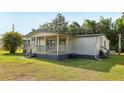 Cozy home boasting a covered porch and well-maintained lawn at 1981 N County Road 426, Oviedo, FL 32765