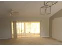 Bright living room with vaulted ceilings and sliding doors to screened in lanai at 21708 Royal St Georges Ln, Leesburg, FL 34748