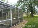 Spacious screened-in porch with a view of the backyard at 21708 Royal St Georges Ln, Leesburg, FL 34748