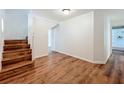 Inviting entryway boasts wood-look floors and a staircase leading to the upper level at 3019 Page Ave, Orlando, FL 32806