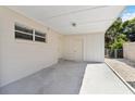 Attached carport with a concrete slab, additional storage, and easy access to the home at 315 Tulane Dr, Altamonte Springs, FL 32714