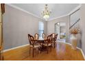 Formal dining room with hardwood floors, elegant chandelier, and large table at 346 Willet Ave, Apopka, FL 32703