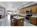 Open kitchen with stainless steel appliances, tile floors, and center island at 346 Willet Ave, Apopka, FL 32703