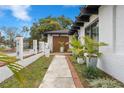 Exterior walkway featuring modern white planters and a brick-lined path, showcasing the home's curb appeal at 409 San Sebastian Prado, Altamonte Springs, FL 32714