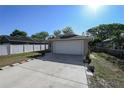 A well-kept single-story home boasts a two-car garage and a tidy, fenced front yard at 443 S Observatory Dr, Orlando, FL 32835