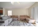 Spacious living room featuring a plush sectional sofa and stylish patterned rug at 443 S Observatory Dr, Orlando, FL 32835