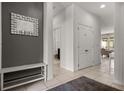 Hallway features neutral paint, tiled floors, and easy access to different areas of the home at 4722 Terrasonesta Dr, Davenport, FL 33837
