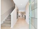Bright foyer with stairs, tiled floor, and open view to the living area offering a welcoming entrance at 5044 Starling Bird Ln, St Cloud, FL 34771