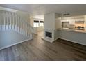Inviting living room featuring hardwood floors, fireplace, and an open layout to the kitchen at 5126 Picadilly Circus Ct # 11, Orlando, FL 32839
