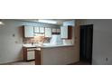 Cozy kitchen with white cabinets, tile backsplash, and modern appliances at 625 Dory Ln # 204, Altamonte Springs, FL 32714