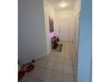 Inviting entryway featuring tiled flooring and a stylish console table with artwork at 6434 Cava Alta Dr # 303, Orlando, FL 32835