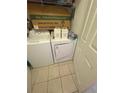 Functional laundry area featuring a stacked washer and dryer, perfect for convenience at 6434 Cava Alta Dr # 303, Orlando, FL 32835