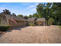 Circular brick driveway with ample parking leading to the attached garage at 677 Benitawood Ct, Winter Springs, FL 32708