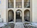 A view of the condo's entrances featuring a wrought iron gate and beautiful archways at 702 E Church St # 3, Orlando, FL 32801