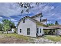 View of rear exterior featuring a covered patio, and tidy yard at 712 Grandview Ave, Altamonte Springs, FL 32701