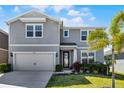 Inviting two-story home with a manicured lawn, attractive landscaping, and a convenient two-car garage at 7649 Ragusa Way, Clermont, FL 34714