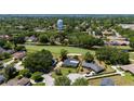 An aerial view of a home overlooking a lush golf course and a scenic community at 7655 Persian Ct, Orlando, FL 32819