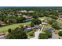 Aerial view of home with lush golf course and mature trees at 7655 Persian Ct, Orlando, FL 32819
