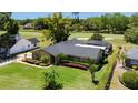 An exterior view of a home with a screened pool, manicured lawn and mature landscaping at 7655 Persian Ct, Orlando, FL 32819