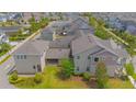 Aerial view of a home featuring a stone patio and a well-maintained backyard within a residential community at 7831 Dausset St, Orlando, FL 32827
