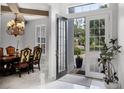 Bright foyer with marble floors offering views into the dining room and out to the landscaped front yard at 11014 Hawkshead Ct, Windermere, FL 34786