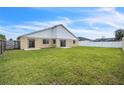 Expansive backyard features a tall white fence, providing ample space for recreation and relaxation at 117 Honeywood Dr, Kissimmee, FL 34743