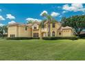 Beautifully landscaped front yard and circular driveway lead to this impressive two-story home at 12222 Cypress Landing Ave, Clermont, FL 34711